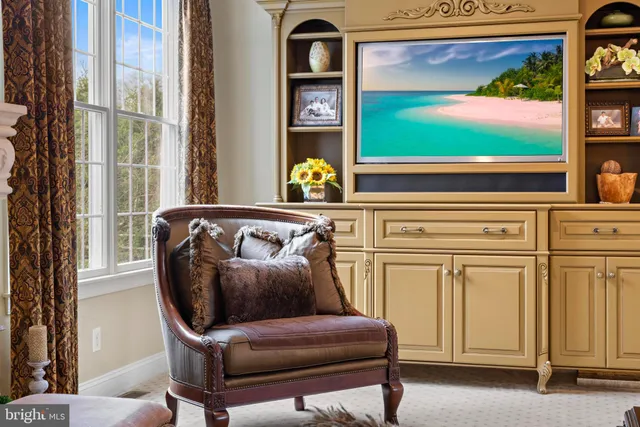 a living room with furniture a table and a flat screen tv