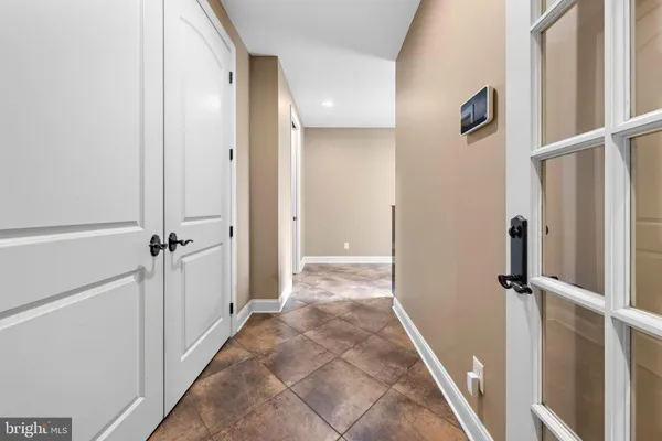 a green field with lots of trees in the background