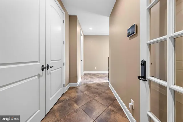 a green field with lots of trees in the background