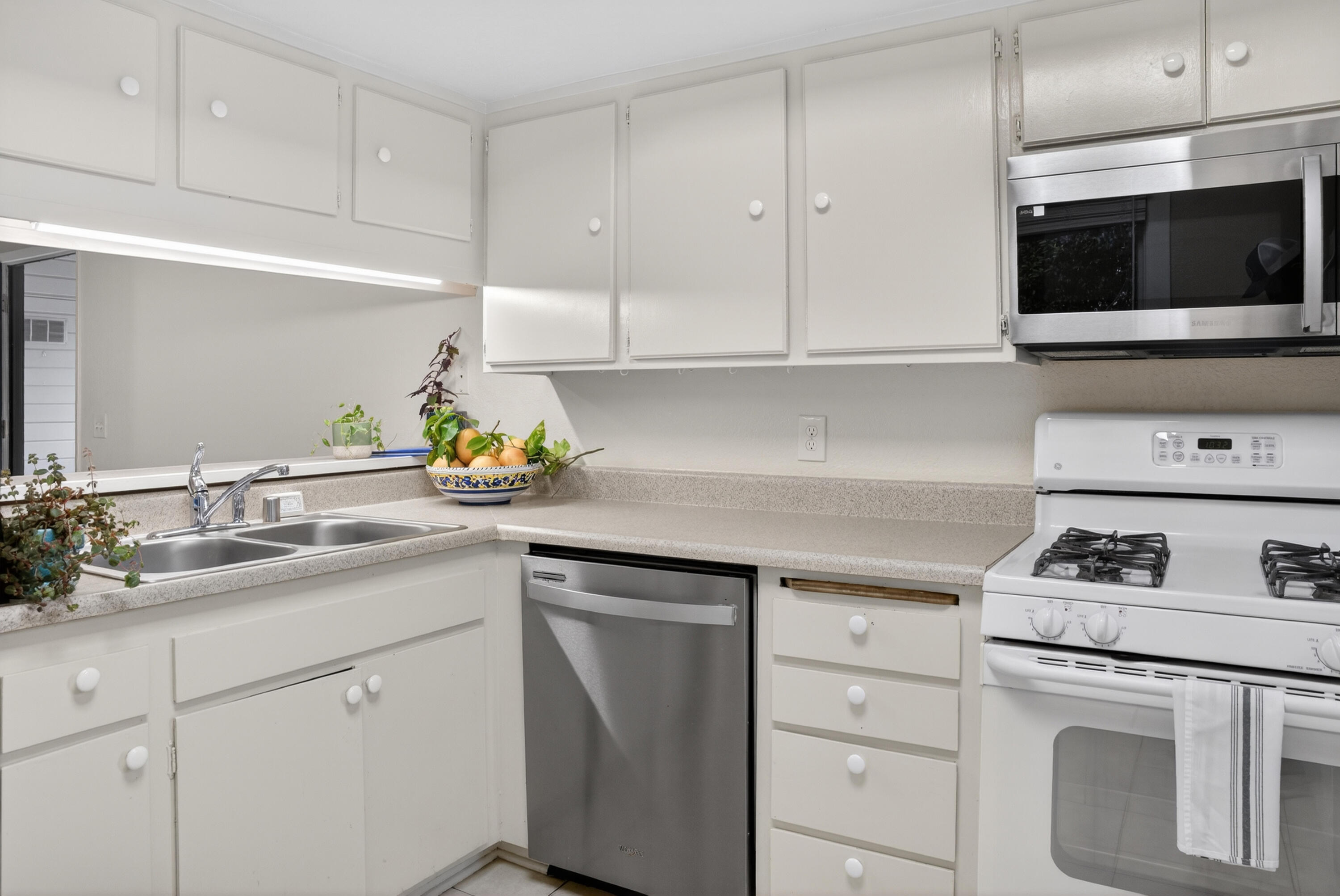 521 West Montecito Street, Unit 1 Santa Barbara, CA 93101 - Photo 4 of 36 a kitchen with white cabinets and appliances