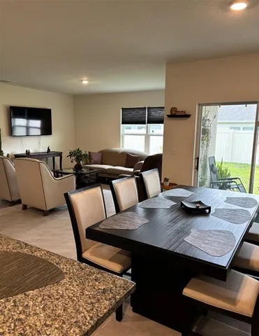 a view of kitchen with granite countertop window and wooden floor