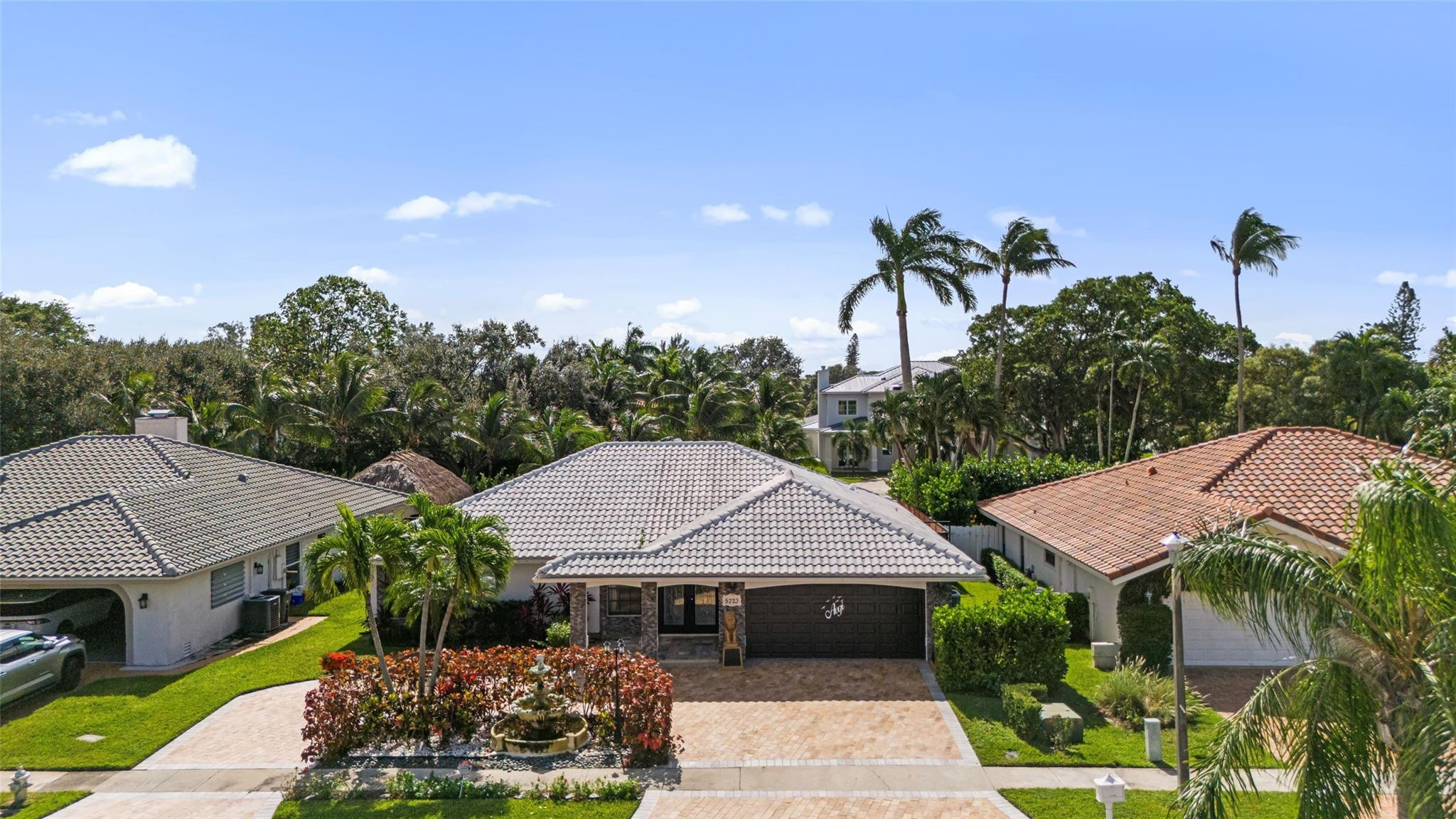 5223 Deerhurst Crescent Circle Boca Raton, FL 33486 - Photo 2 of 51 a front view of a house with a garden