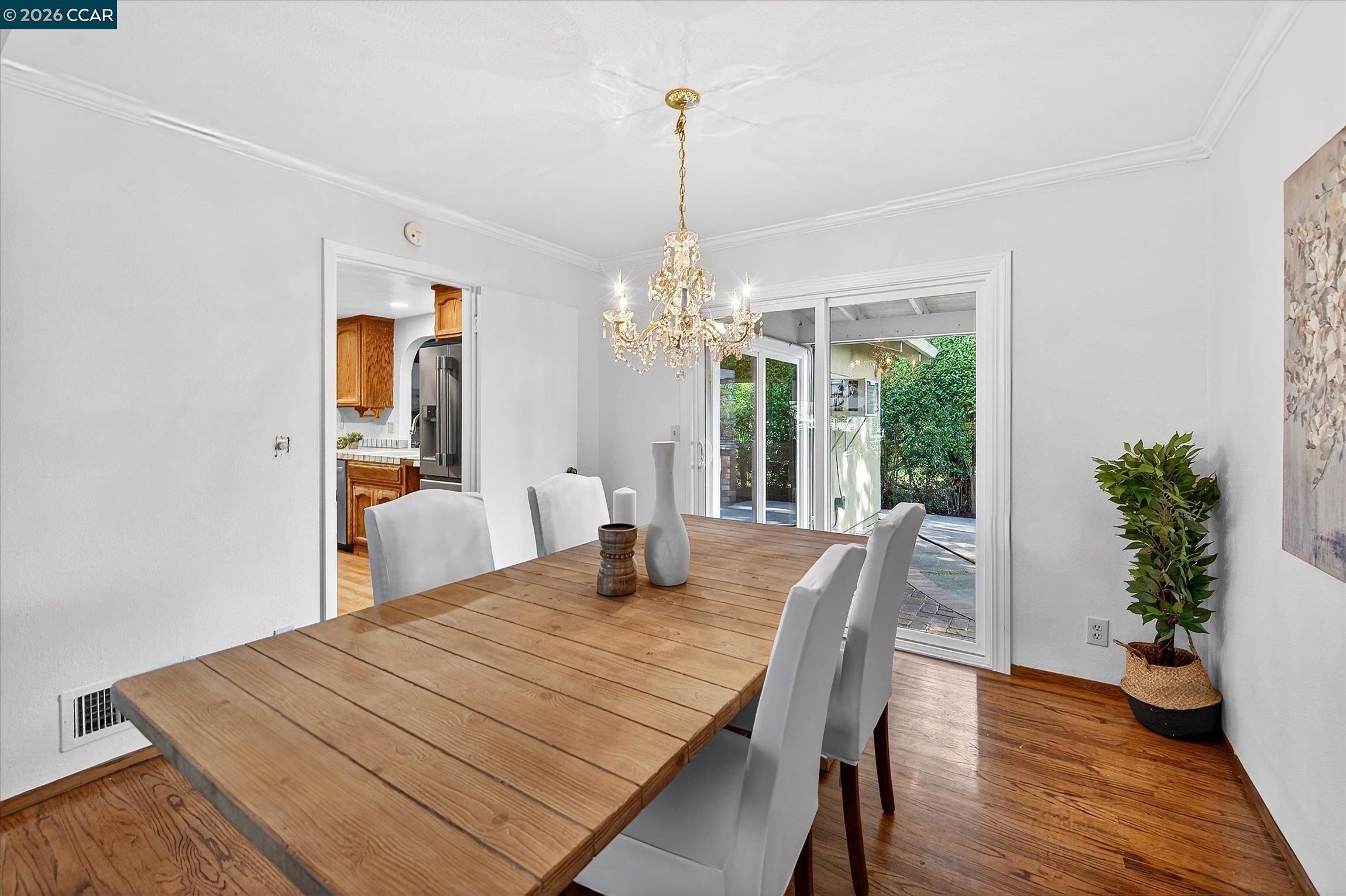 27 Milburn Court San Ramon, CA 94583 - Photo 12 of 41 a dining room with wooden floor a chandelier a wooden table and chairs