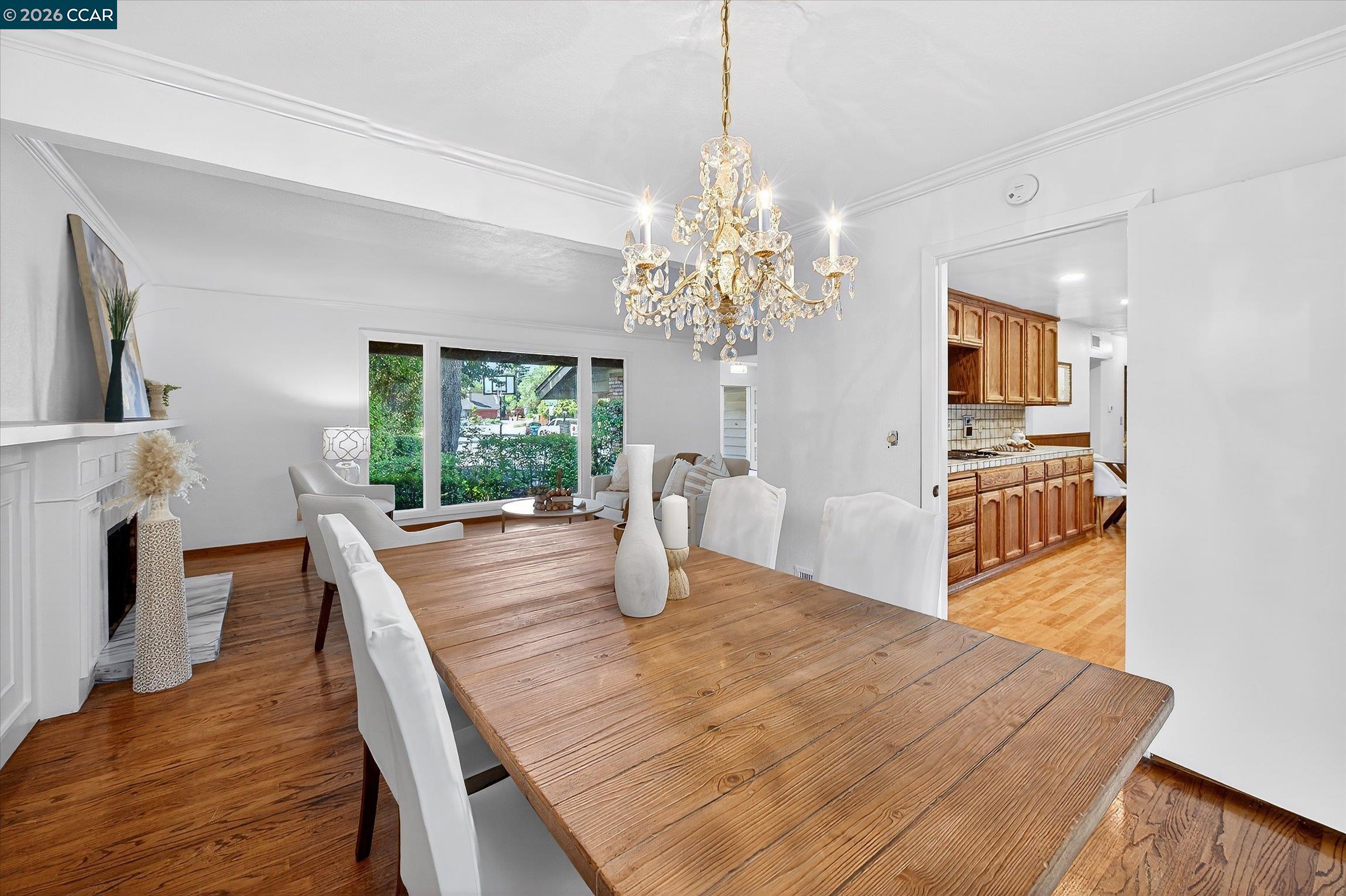 27 Milburn Court San Ramon, CA 94583 - Photo 13 of 41 a dining room with wooden floor a chandelier a wooden table and chairs