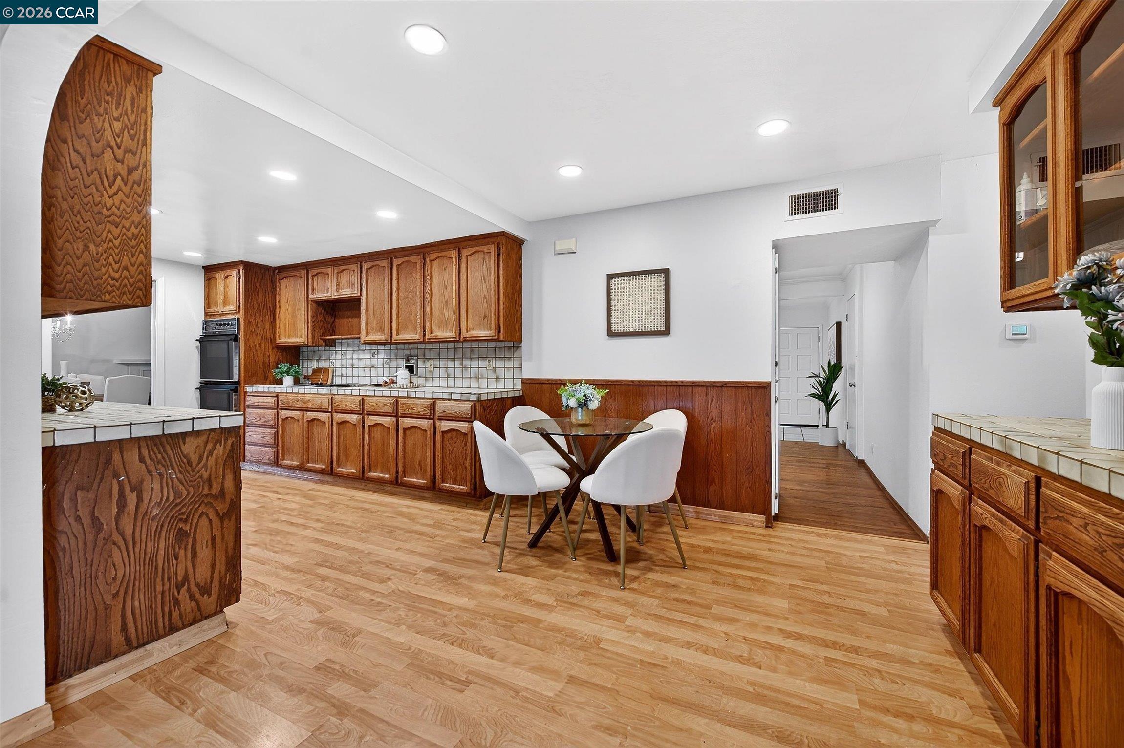 27 Milburn Court San Ramon, CA 94583 - Photo 16 of 41 a living room with stainless steel appliances furniture and a wooden floor