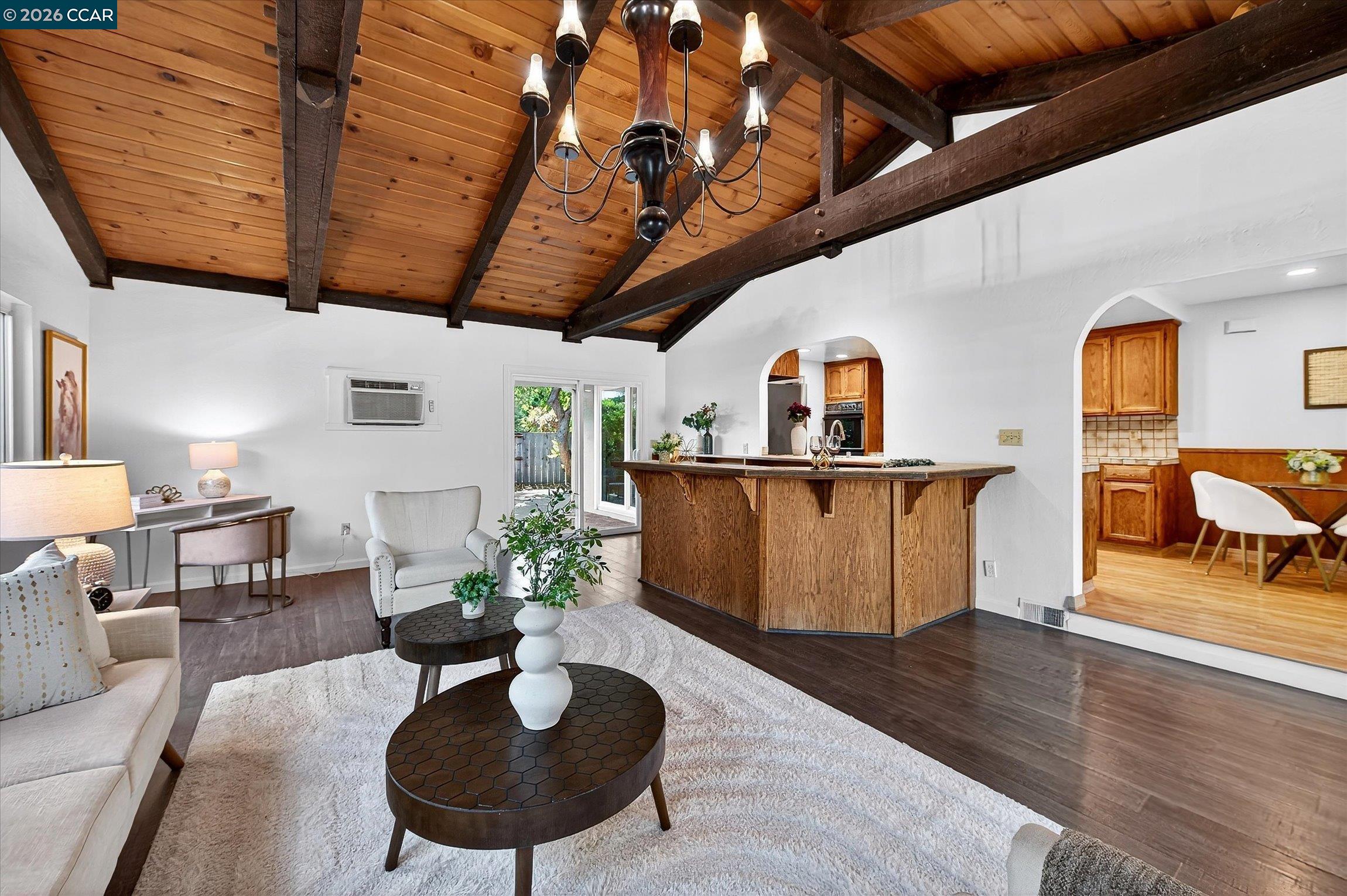 27 Milburn Court San Ramon, CA 94583 - Photo 22 of 41 a living room with furniture a chandelier and a wooden floor
