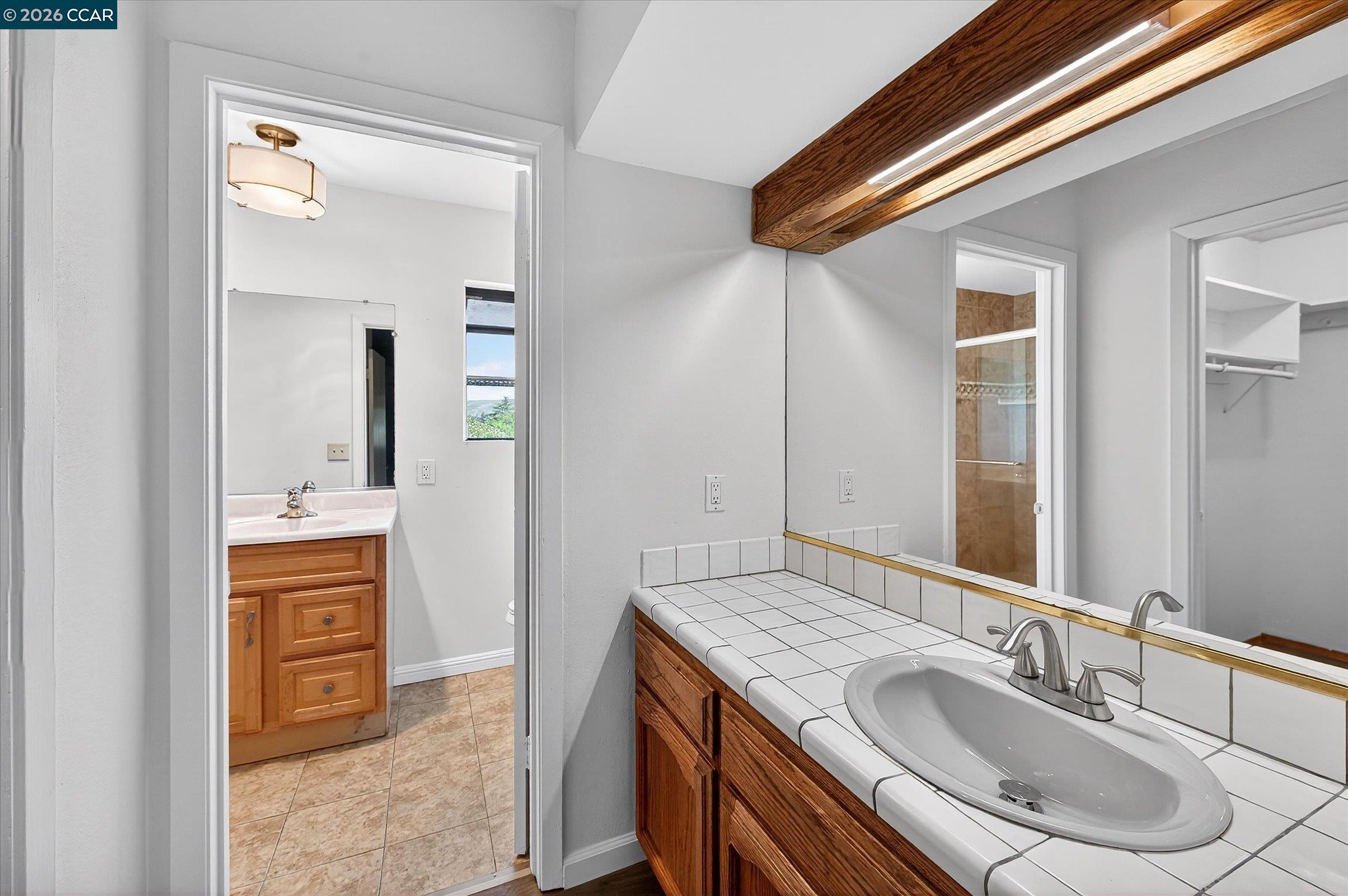 27 Milburn Court San Ramon, CA 94583 - Photo 26 of 41 a bathroom with a granite countertop sink and a mirror