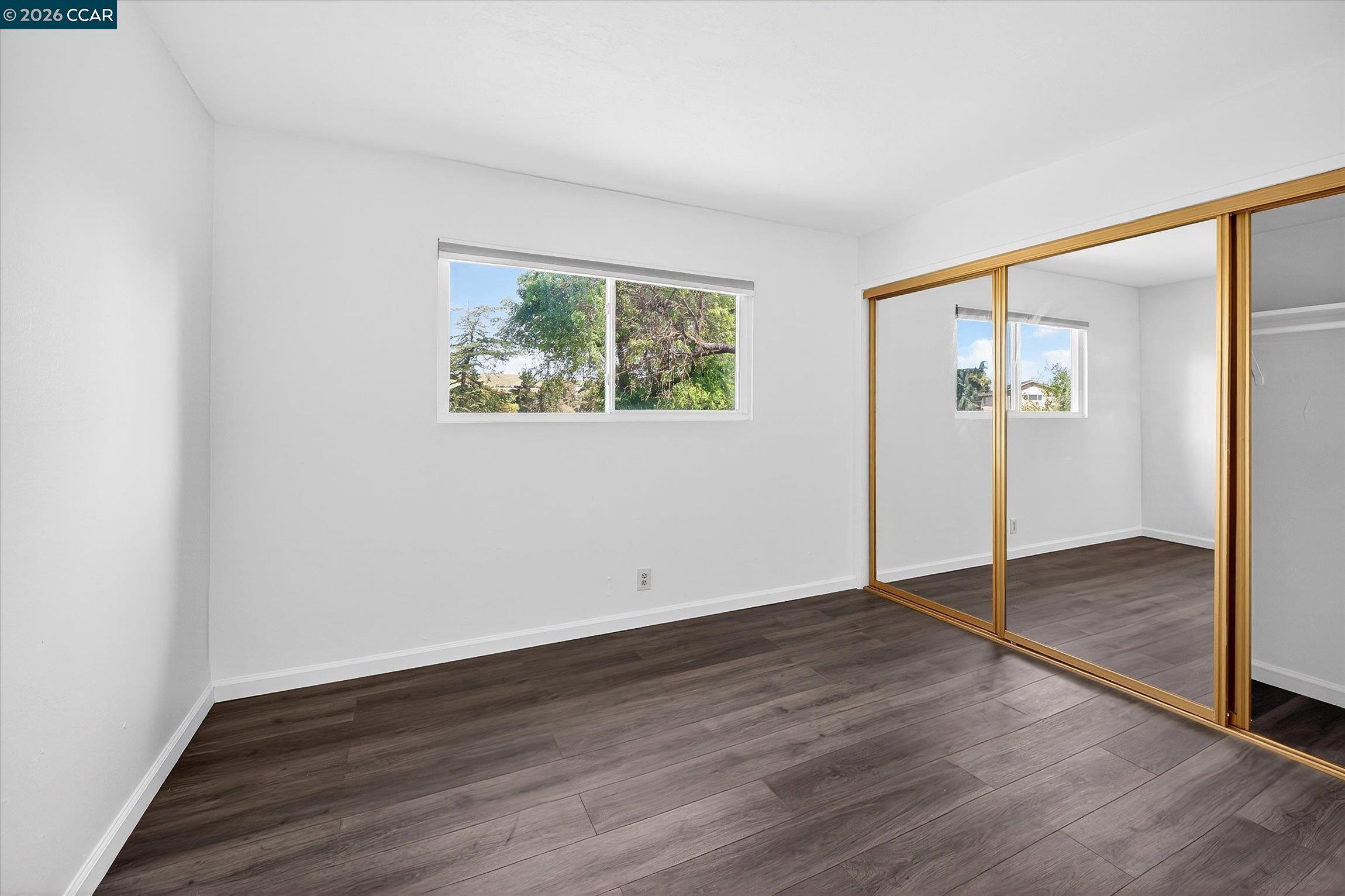 27 Milburn Court San Ramon, CA 94583 - Photo 31 of 41 an empty room with wooden floor and window