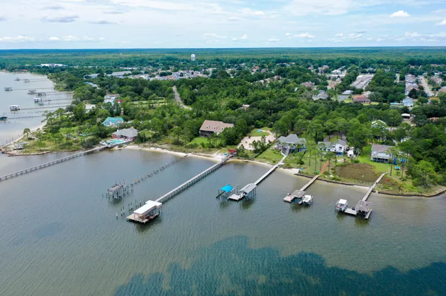 an aerial view of a house with a yard basket ball court