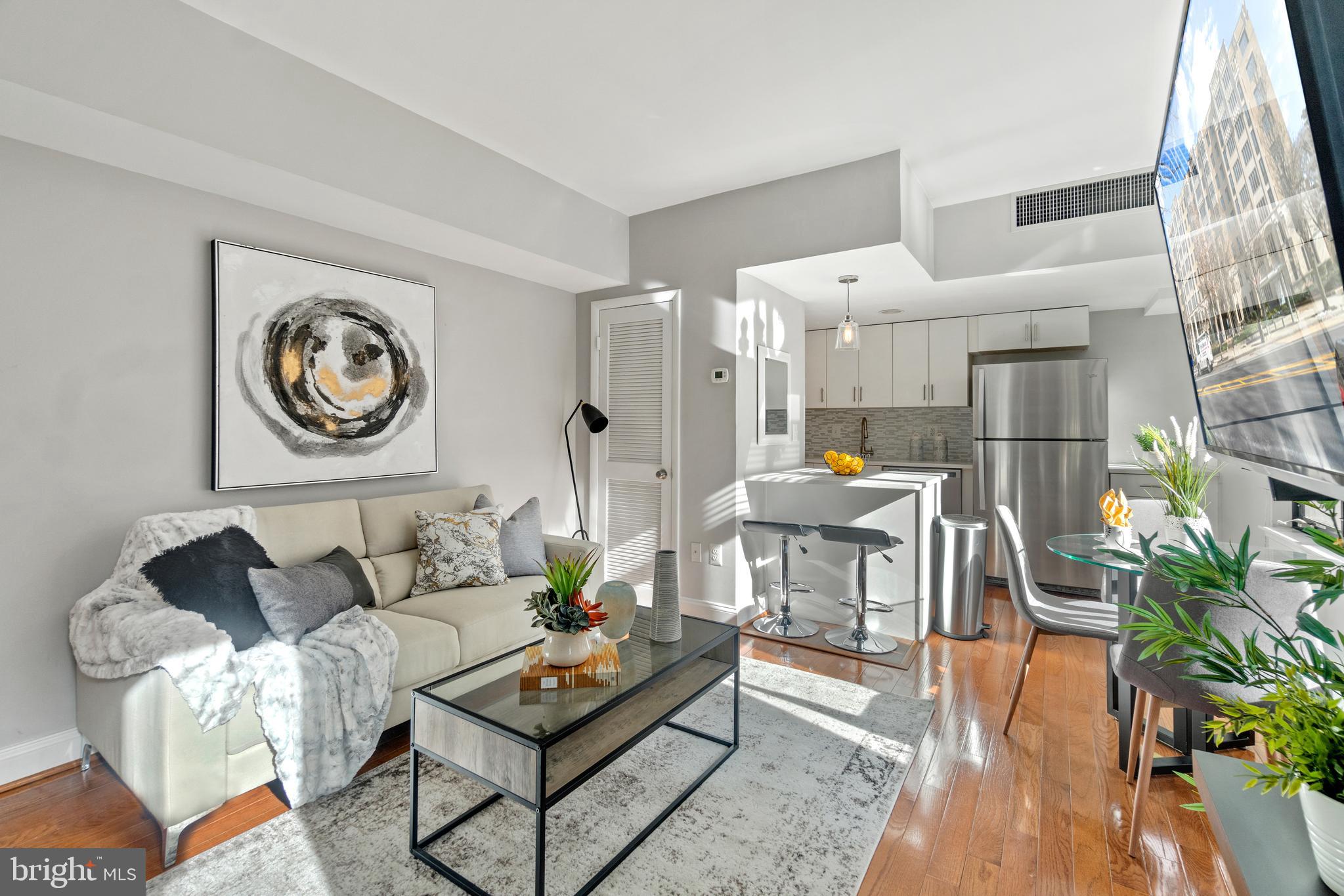 a living room with furniture and wooden floor