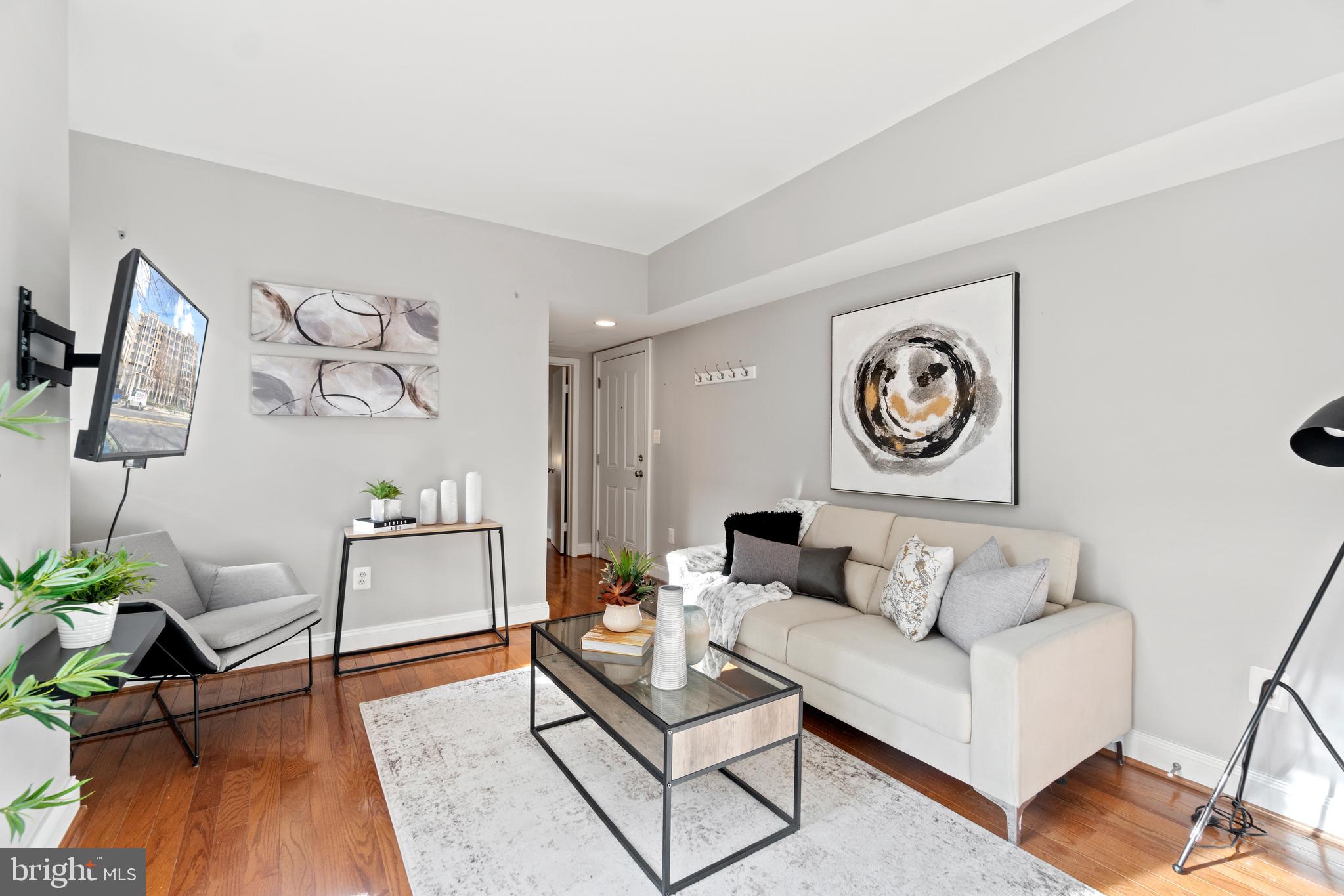 1701 16th Street Northwest, Unit 421 Washington, DC 20009 - Photo 2 of 20 a living room with furniture and wooden floor