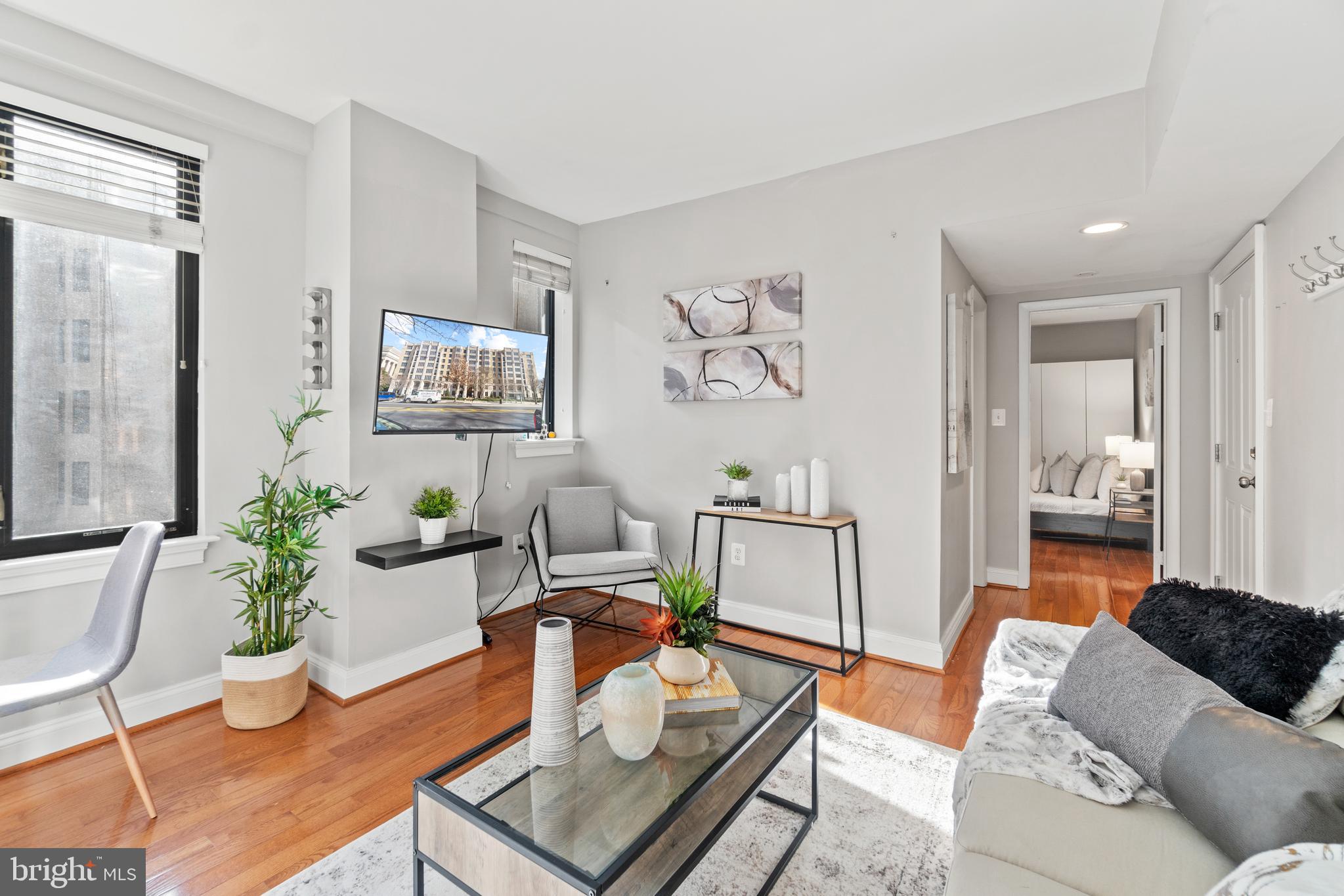 1701 16th Street Northwest, Unit 421 Washington, DC 20009 - Photo 3 of 20 a living room with furniture and wooden floor