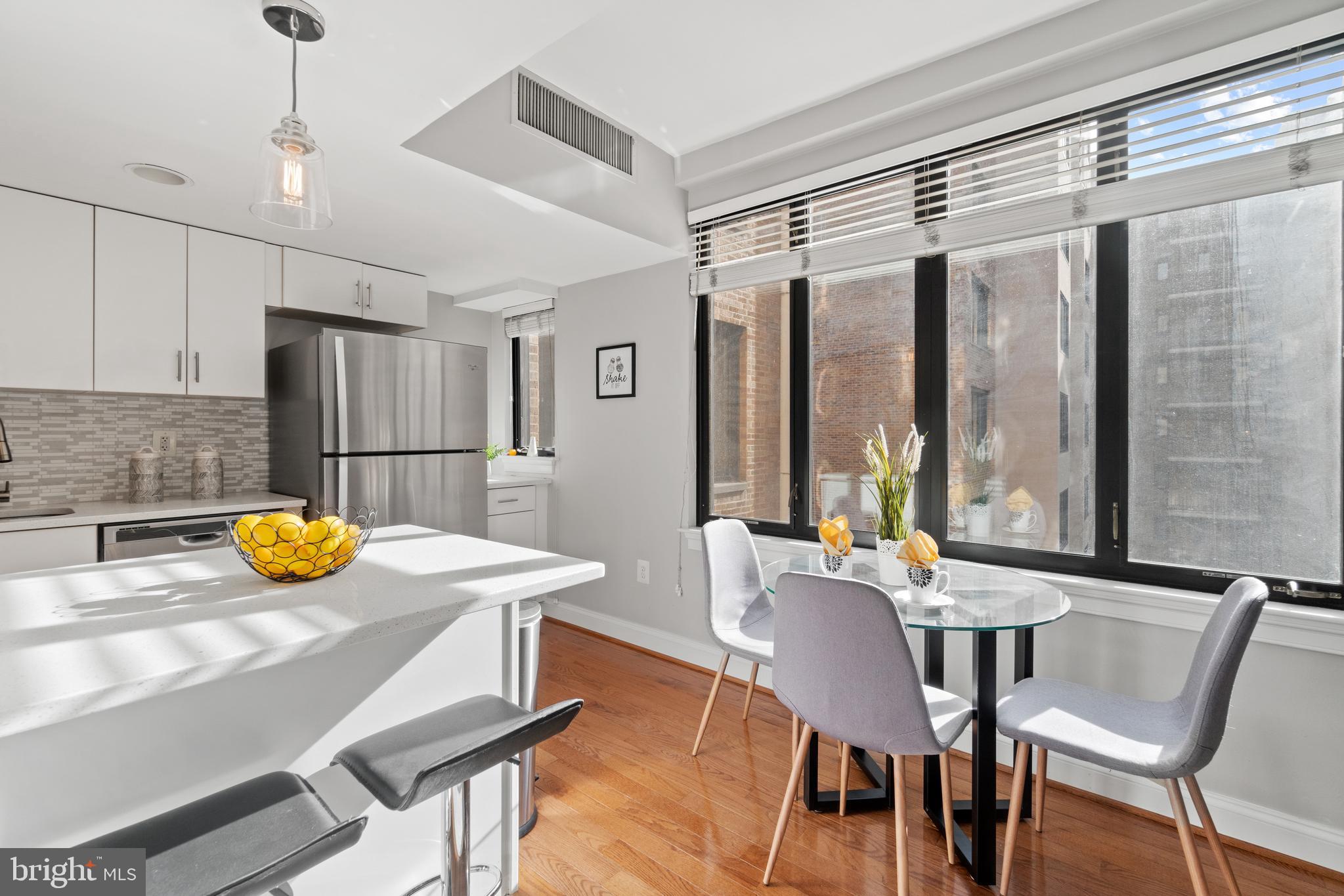 1701 16th Street Northwest, Unit 421 Washington, DC 20009 - Photo 5 of 20 a view of a dining room with furniture window and outside view
