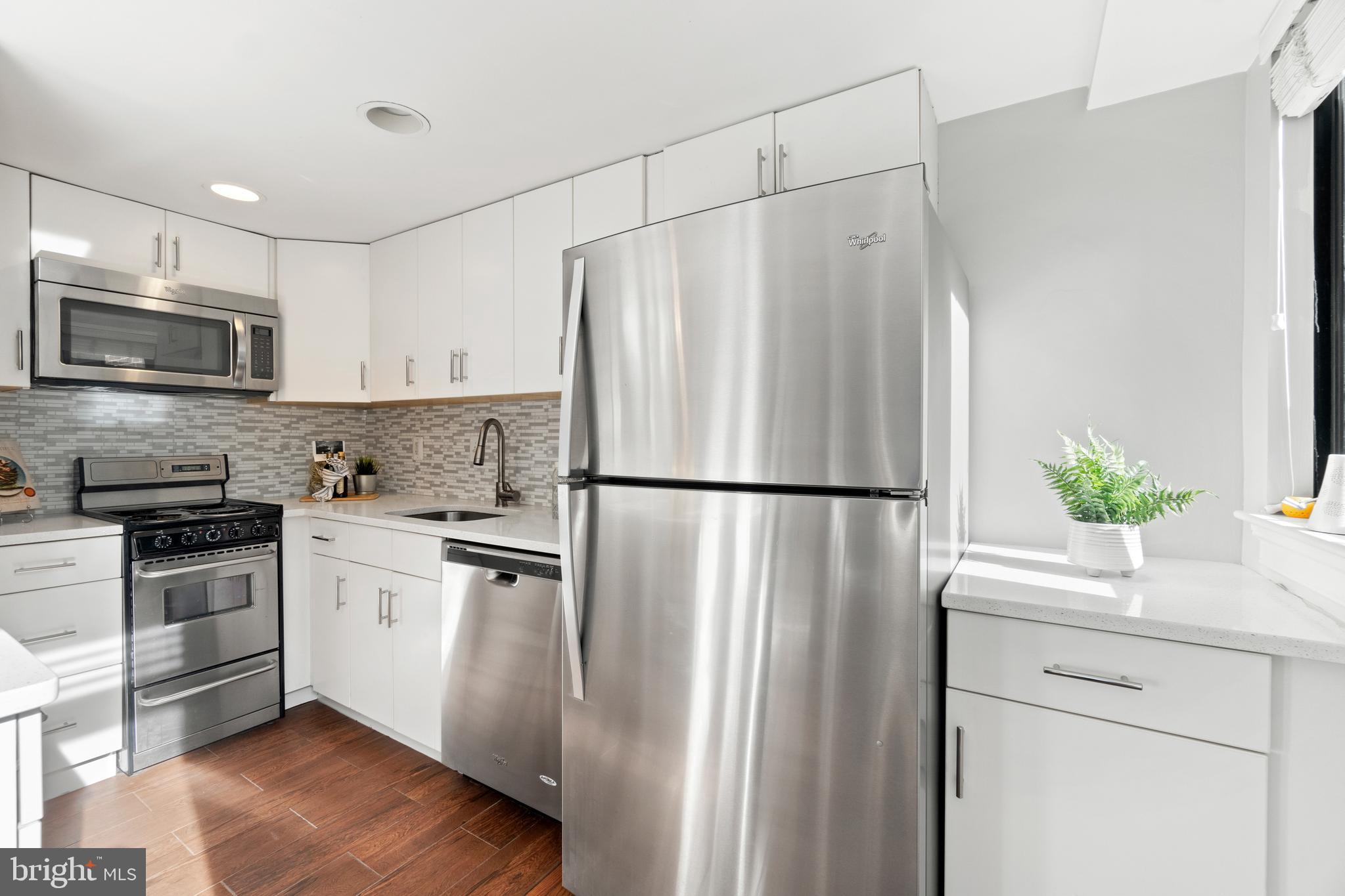 1701 16th Street Northwest, Unit 421 Washington, DC 20009 - Photo 10 of 20 a kitchen with stainless steel appliances a refrigerator a sink cabinets and a microwave