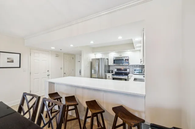 a living room with furniture a flat screen tv and a large window