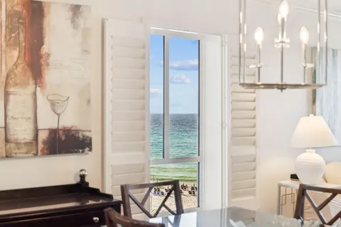 a bedroom with a bed and large window