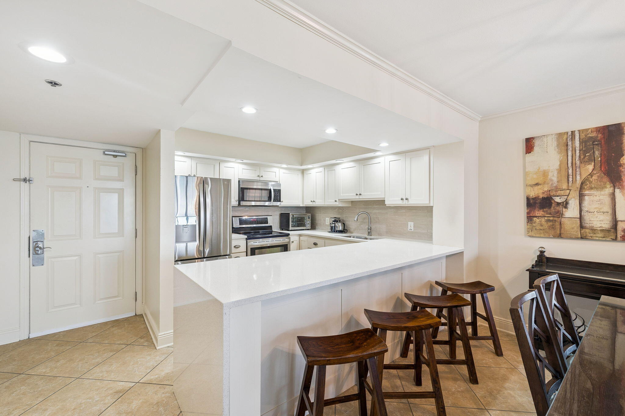 4253 Beachside 2, Unit 4253 Miramar Beach, FL 32550 - Photo 10 of 92 a kitchen with kitchen island a stove a table and chairs
