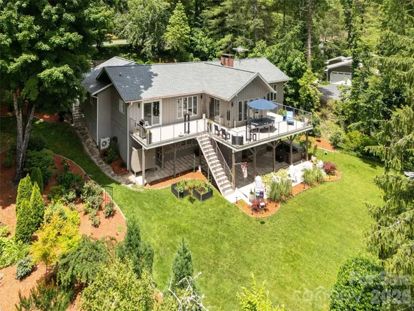 an aerial view of a house with swimming pool garden and patio