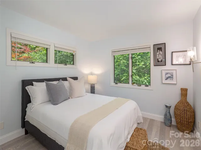 a bathroom with a toilet sink double vanity and mirror