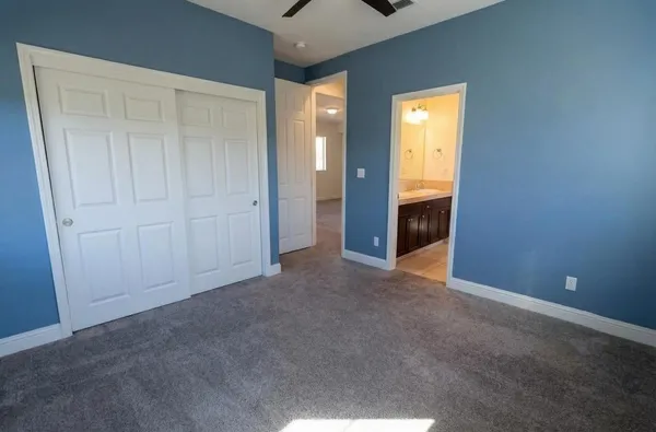 an empty room with windows and closet