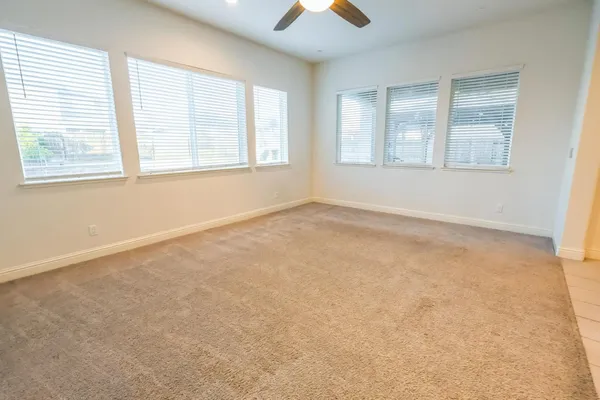 an empty room with windows and closet