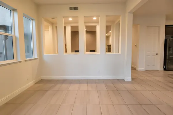 a bathroom with a double vanity sink large mirror and a bathtub
