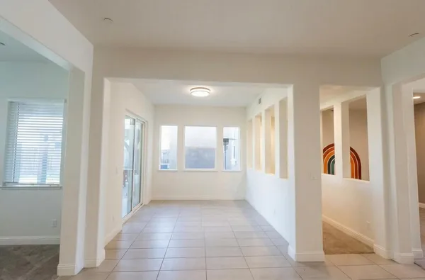 a view of a porch with chairs and backyard
