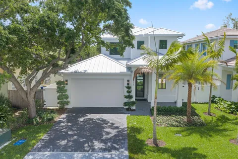 a front view of a house with a yard and a garage