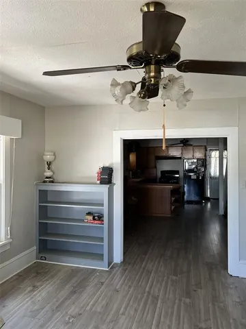 a kitchen with stainless steel appliances kitchen island granite countertop a stove a sink a refrigerator and cabinets