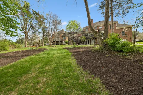 a front view of a house with a garden and plants