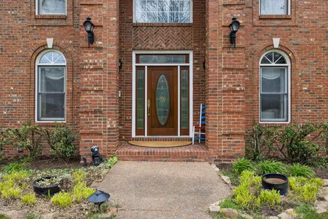 a front view of a house with a garden