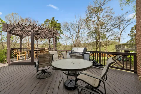a view of a chairs and table on the deck in the patio