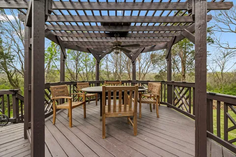 a view of a dinning table and chairs in patio with wooden floor