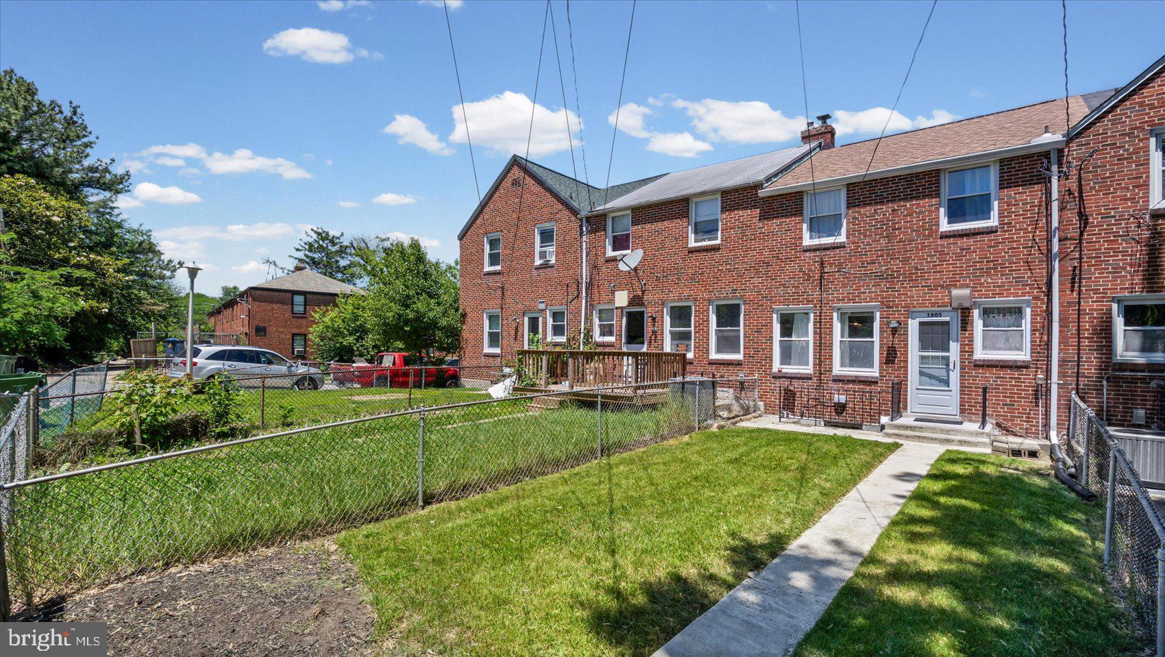 1805 Crestview Road Baltimore, MD 21239 - Photo 35 of 39 a front view of a house with a yard table and chairs