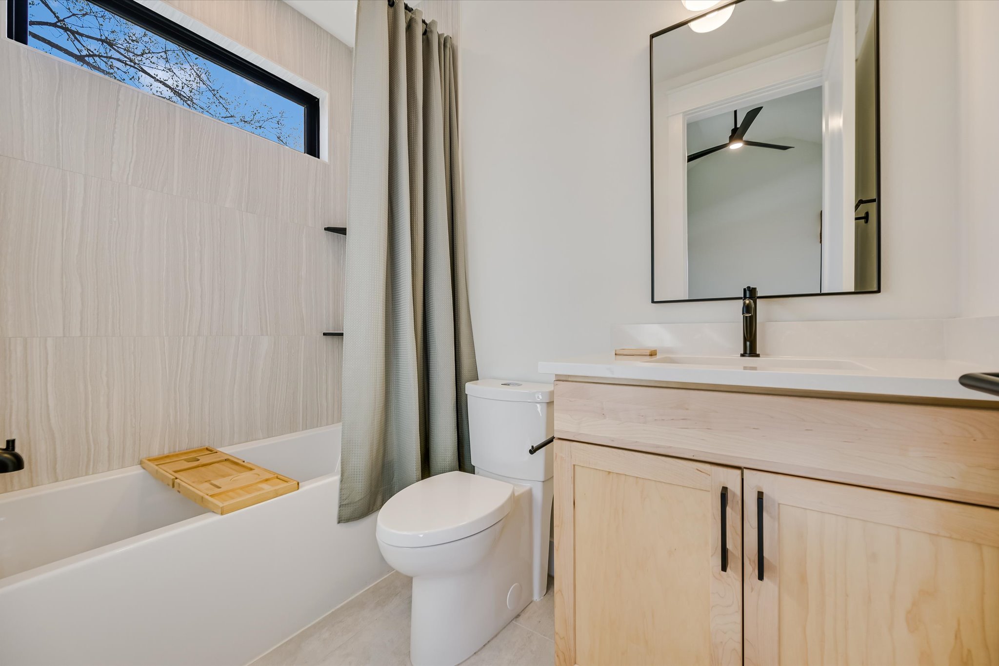 3503 Kay Street, Unit 2 Austin, TX 78702 - Photo 13 of 19 a bathroom with a sink a toilet and shower curtain