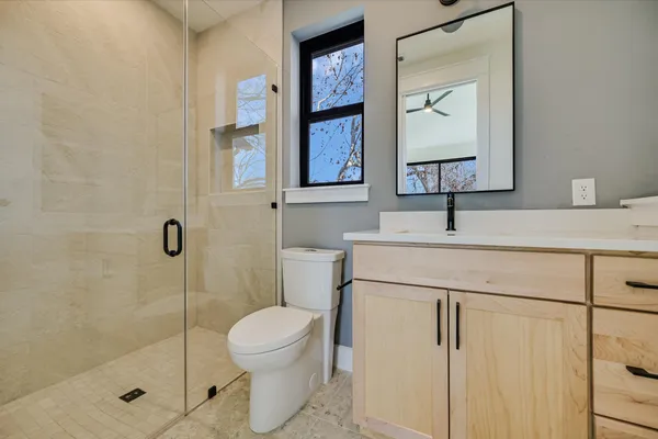 a bathroom with a sink toilet and shower