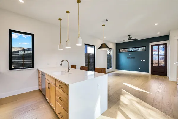 a kitchen with stainless steel appliances granite countertop a sink and dishwasher with white cabinets