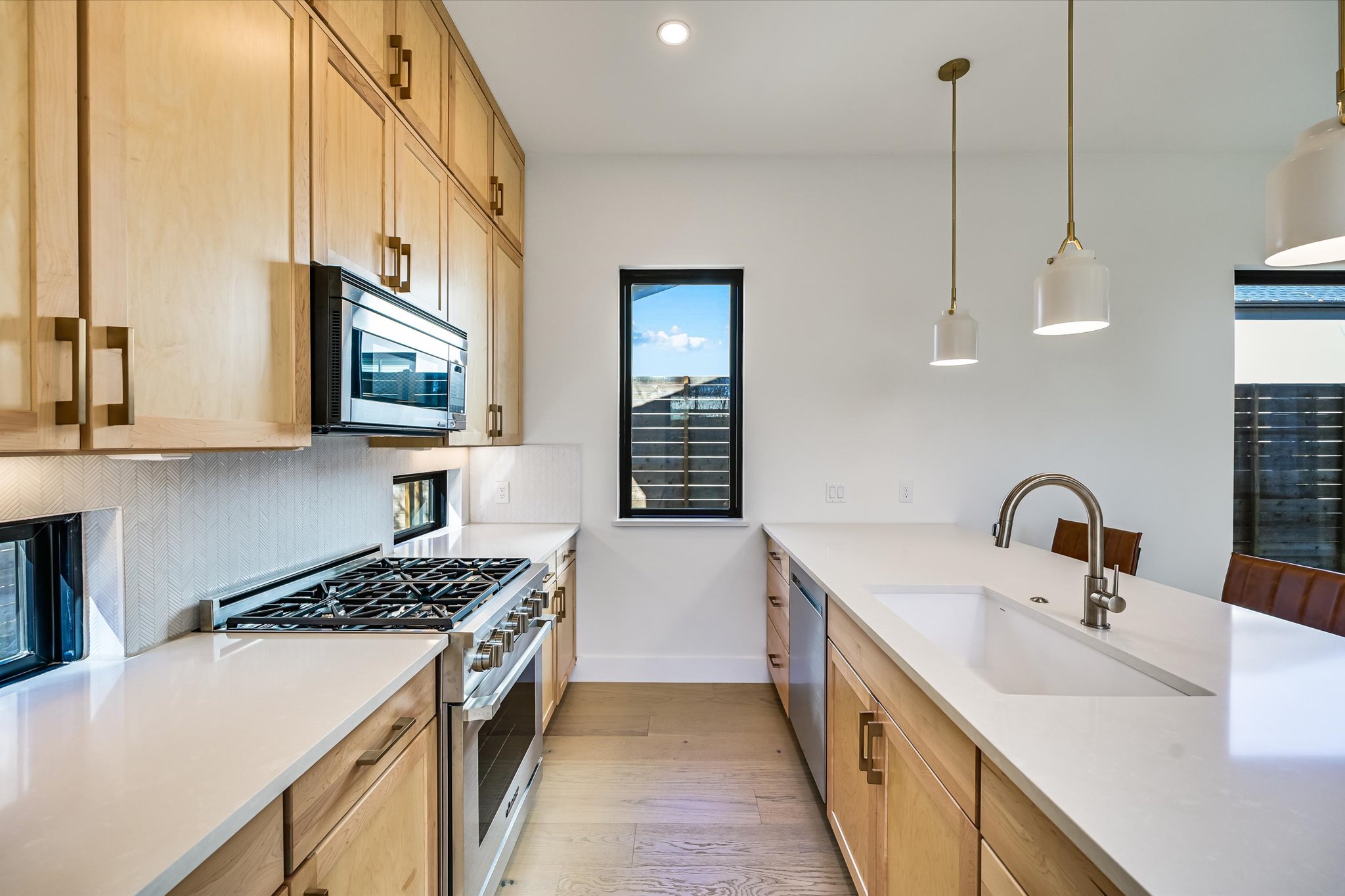 3503 Kay Street, Unit 2 Austin, TX 78702 - Photo 7 of 19 a kitchen with stainless steel appliances a sink a stove top oven a counter space and cabinets