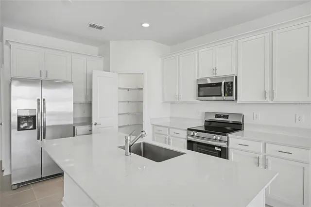 a kitchen with stainless steel appliances granite countertop a stove and a sink