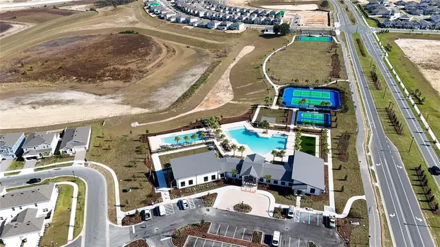 an aerial view of a house with a yard