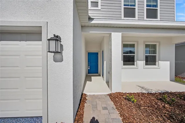 a view of a hallway with wooden floor and entryway