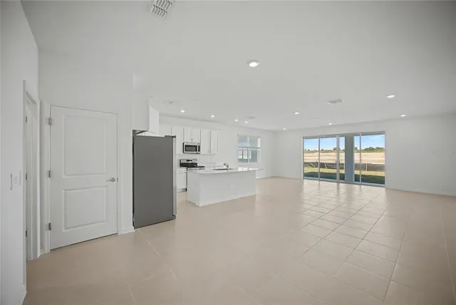 a kitchen with stainless steel appliances a refrigerator and a stove top oven