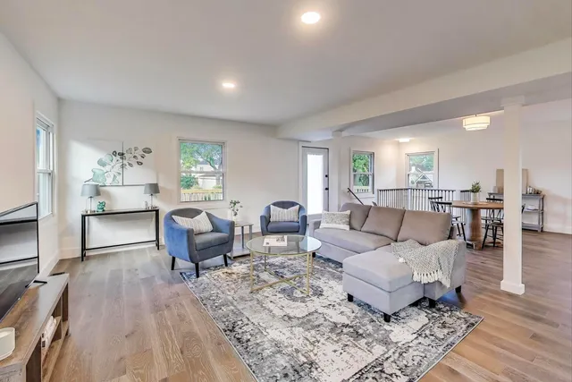 a living room with furniture and a wooden floor