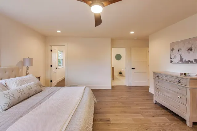 a spacious bedroom with a bed and a chandelier