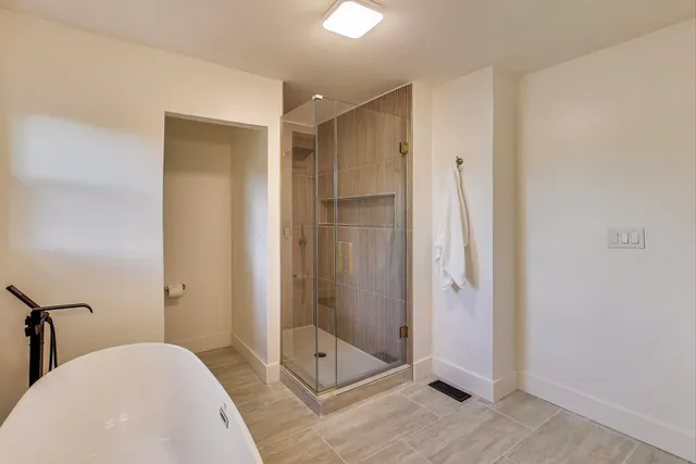 a bathroom with a shower and a sink