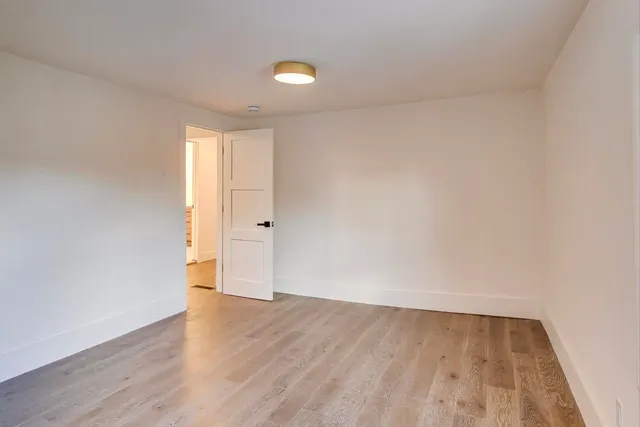 a view of an empty room and wooden floor