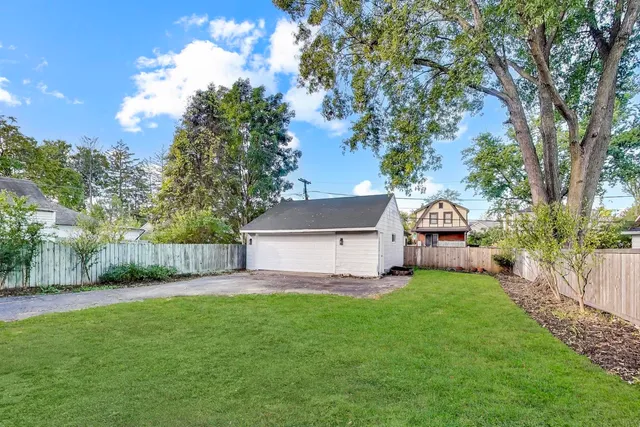a view of a house with a yard and sitting area