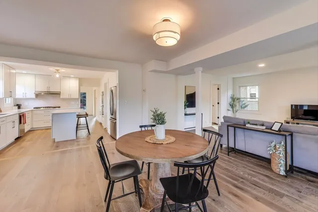 a view of a dining room with furniture and wooden floor