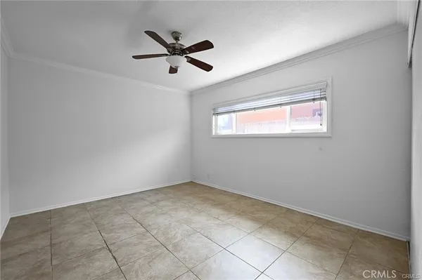 a view of a big room with wooden floor and windows