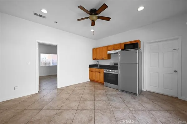 a kitchen with stainless steel appliances a refrigerator and a stove top oven